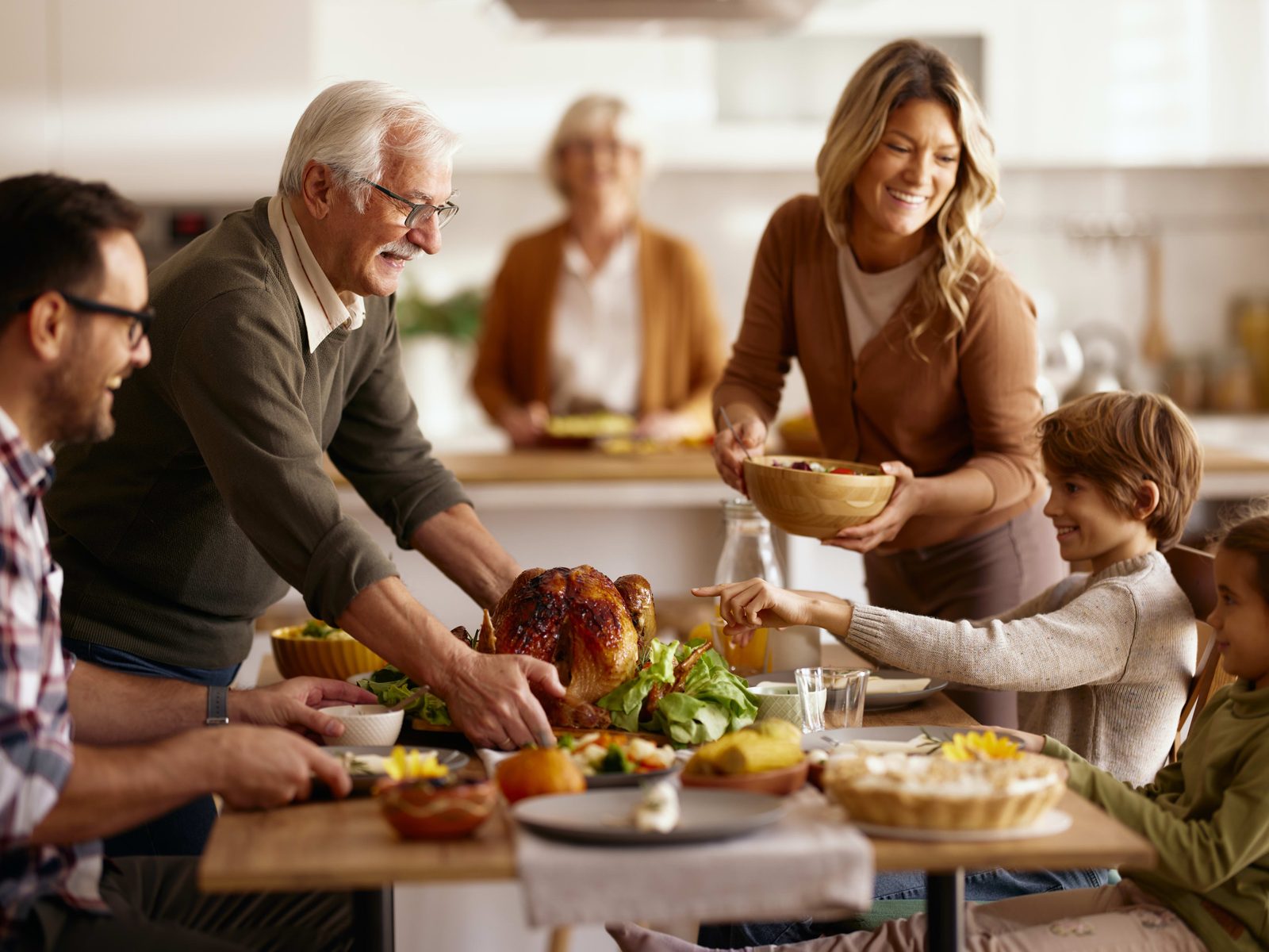 A multigenerational family gathered around a dining table